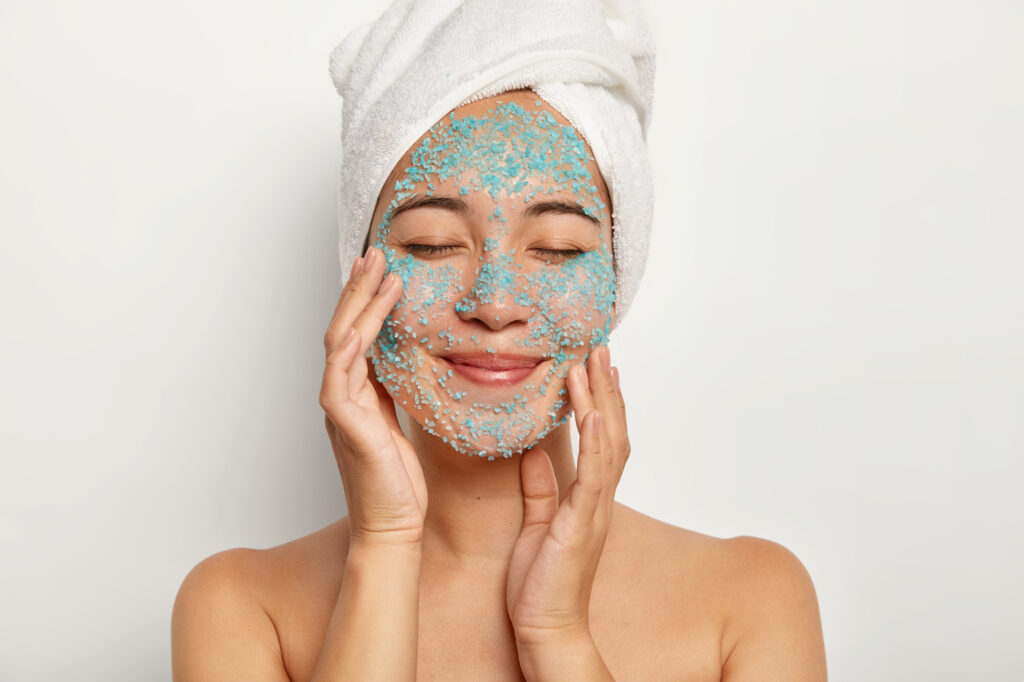 a woman exfoliating her face